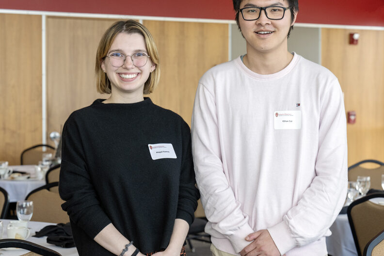 Abigail Komro and Ethan Cui standing side-by-side and smiling