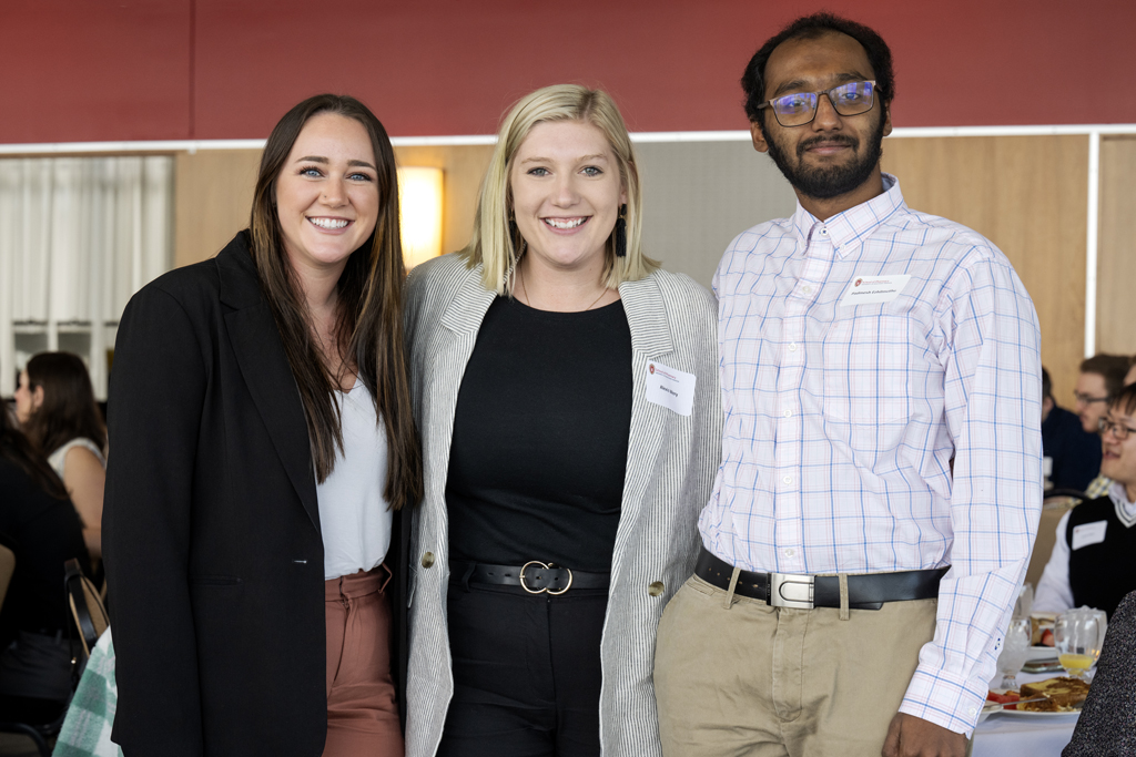 Haley Smith, Alexis Wery, and Padmesh Ezhilmuthu posing arm-in-arm together