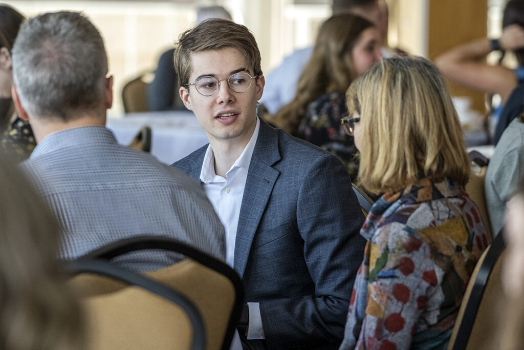 PharmD Student Scholarship Brunch_042021_BGI_6160 Fourth-year PharmD student Alex Peterson talks with his mother, Debbi Peterson, as his father looks on during the 2022 School of Pharmacy Scholarship Brunch