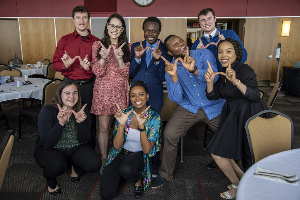 PharmD Student Scholarship Brunch_042021_BGI_6785 PharmD students grab a silly photo op after the 2022 School of Pharmacy Scholarship Brunch. Front row: Madeline Szubert, Maria Hill. Back row: McKay Carstens, Caroline Palay, Vincent Elijah, Michael Nome, Kane Carstens, and Mary Ann Egbujor