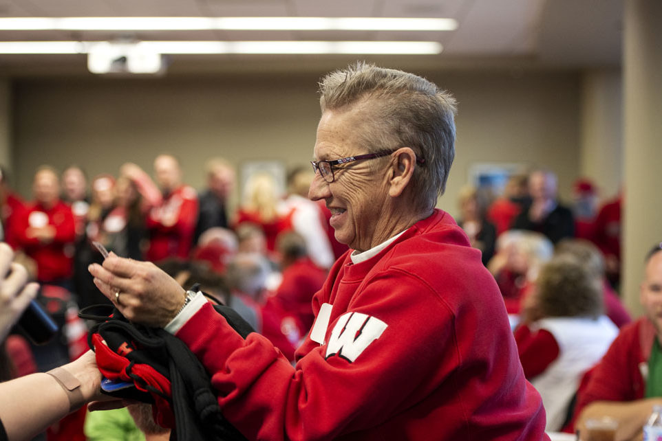 PharmacyAlumniTailgateEvent_1018_DSC_7212 An alumna celebrating a raffle win at the UW-Madison Pharmacy Alumni Tailgate event, held at Union South during the Badgers vs. Cornhuskers game.