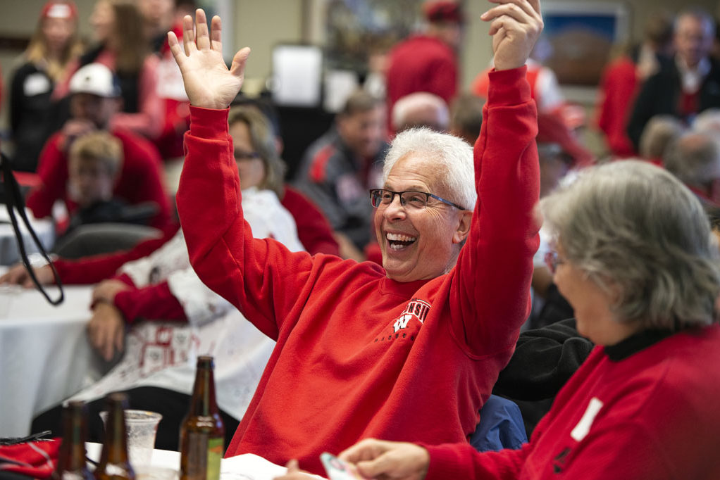 PharmacyAlumniTailgateEvent_1018_DSC_7234 Bob Breslow celebrates a raffle win at the UW-Madison Pharmacy Alumni Tailgate event, held at Union South during the Badgers vs. Cornhuskers game.