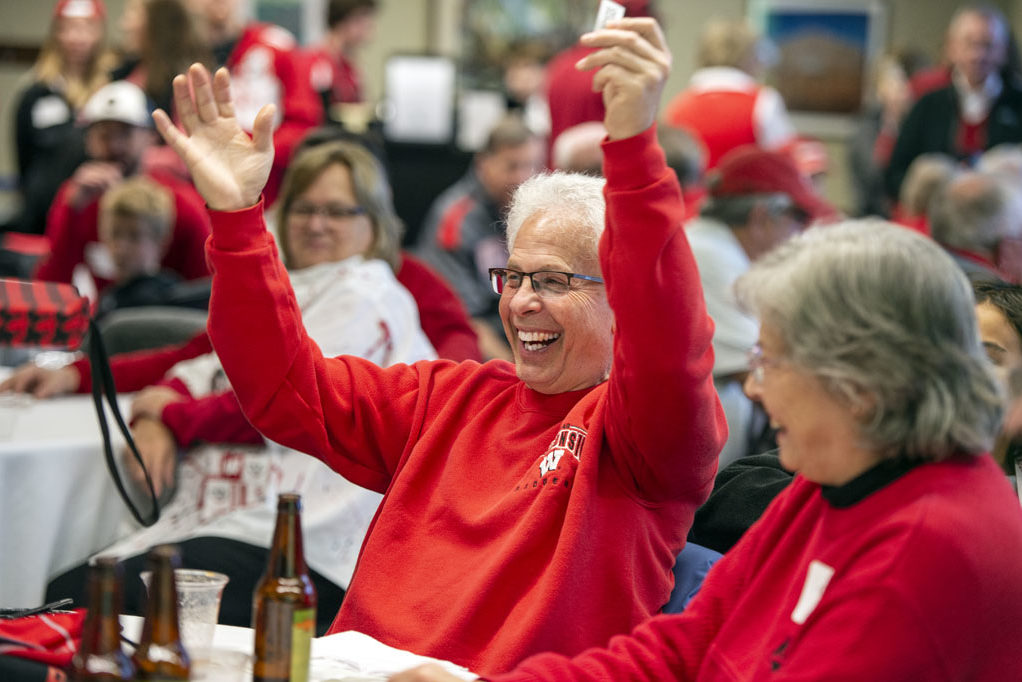 PharmacyAlumniTailgateEvent_1018_DSC_7238 Bob Breslow celebrates a raffle win at the UW-Madison Pharmacy Alumni Tailgate event, held at Union South during the Badgers vs. Cornhuskers game.
