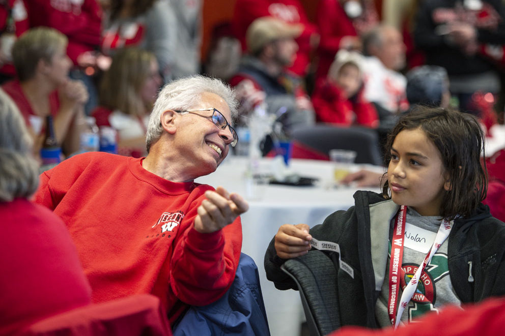 PharmacyAlumniTailgateEvent_1018_DSC_7247 Alumni chat during the raffle portion of the UW-Madison Pharmacy Alumni Tailgate event, held at Union South during the Badgers vs. Cornhuskers game.