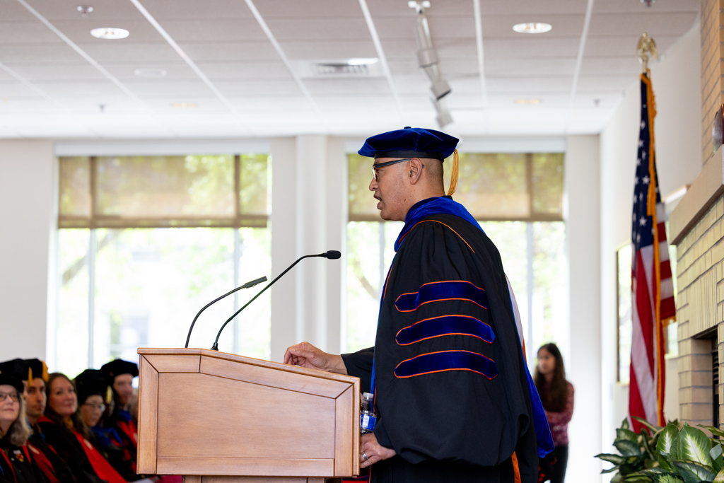 Pharmacy_Graduation_2024_040 Arash Bashirullah speaks at the podium