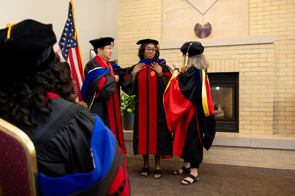 Pharmacy_Graduation_2024_048 A graduate receives her hood
