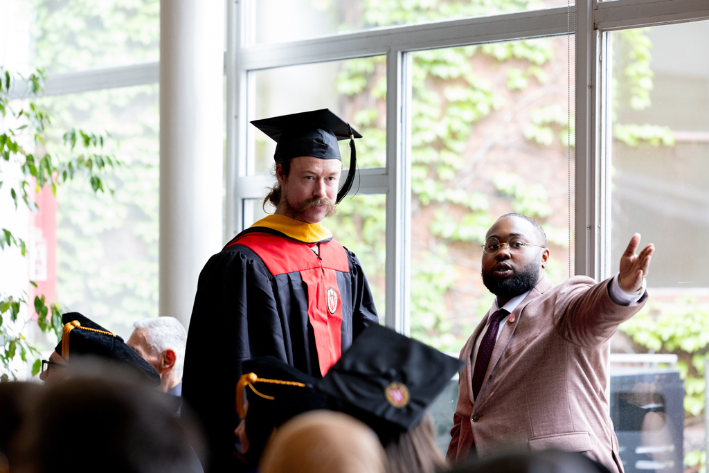 Pharmacy_Graduation_2024_063 Ace Hilliard points a graduate in the right direction