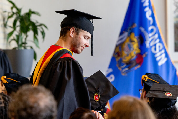 Pharmacy_Graduation_2024_065 A graduate finds his seat