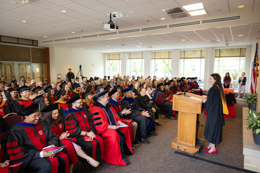 Pharmacy_Graduation_2024_086 Graduate Mika Hess speaks at the podium