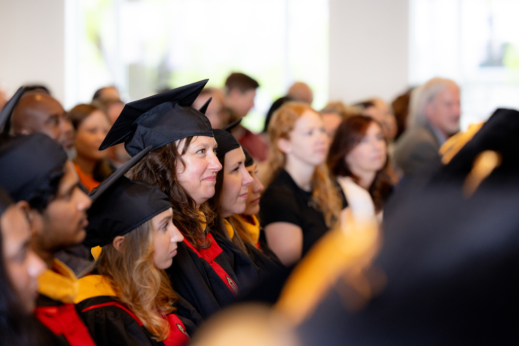Pharmacy_Graduation_2024_095 Graduates listen to the speakers