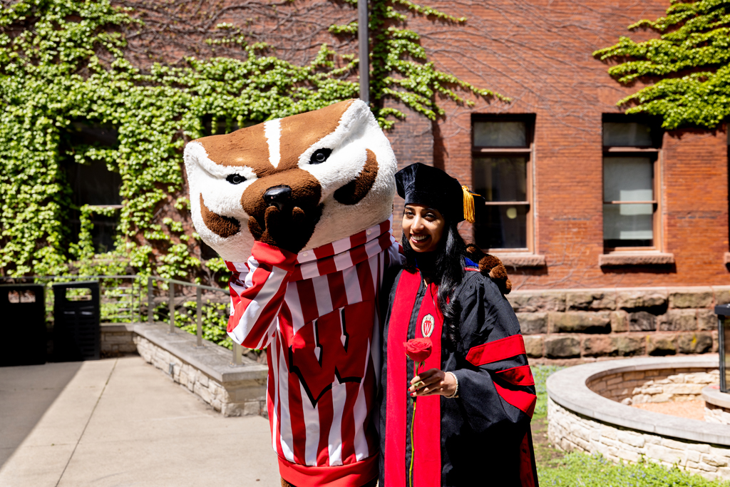 Pharmacy_Graduation_2024_146 A graduate poses with Bucky Badger
