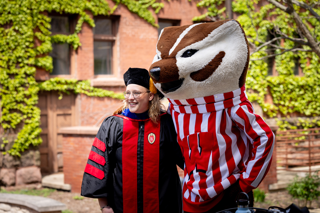 Pharmacy_Graduation_2024_156 A graduate poses with Bucky Badger