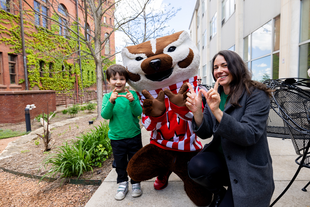 Pharmacy_Graduation_2024_157 A graduate poses with Bucky Badger