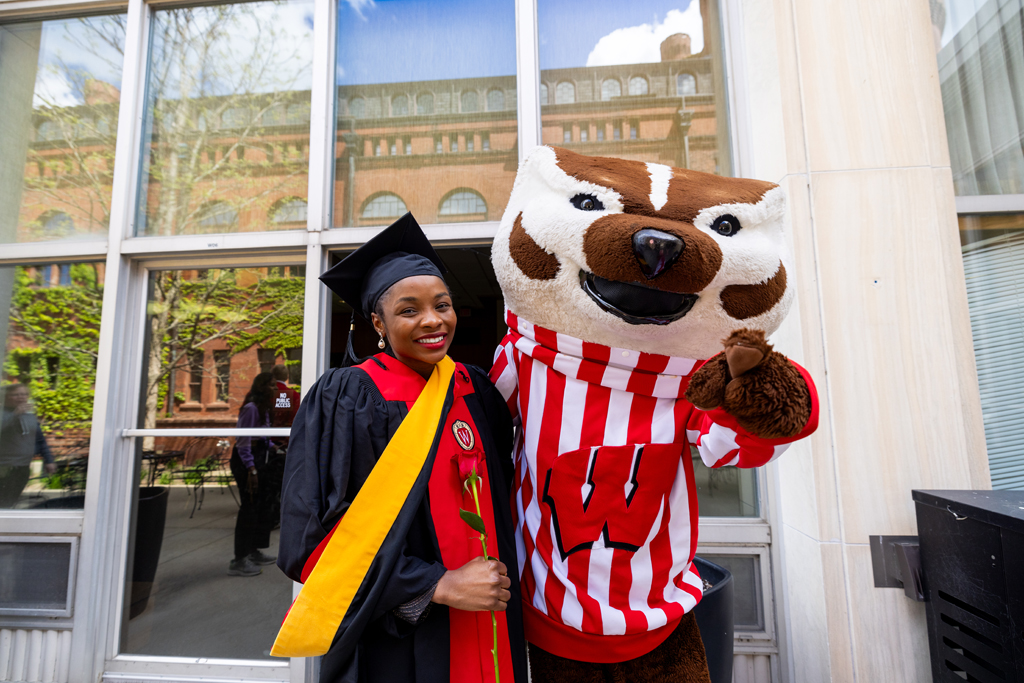 Pharmacy_Graduation_2024_159 A graduate poses with Bucky Badger