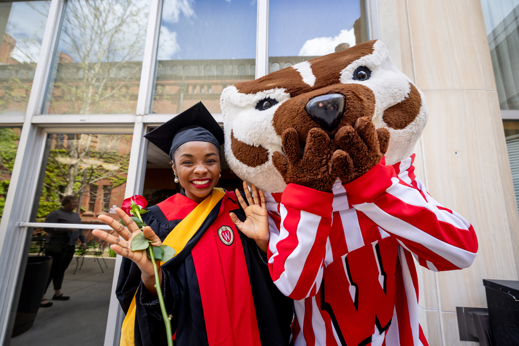 Pharmacy_Graduation_2024_161 A graduate poses with Bucky Badger