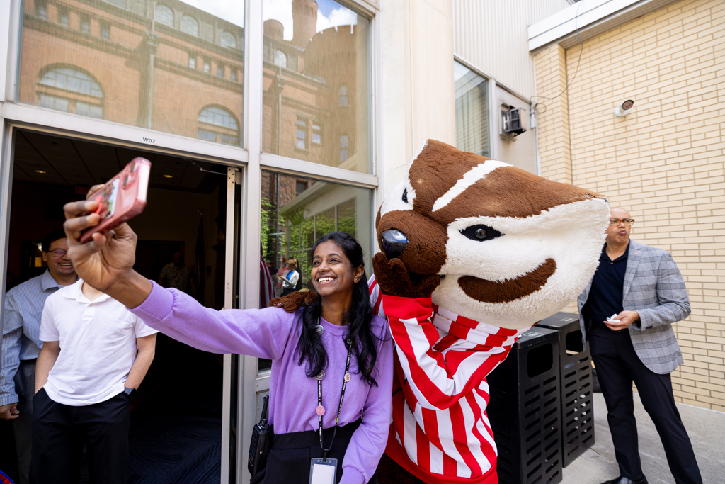 Pharmacy_Graduation_2024_163 A graduate poses with Bucky Badger