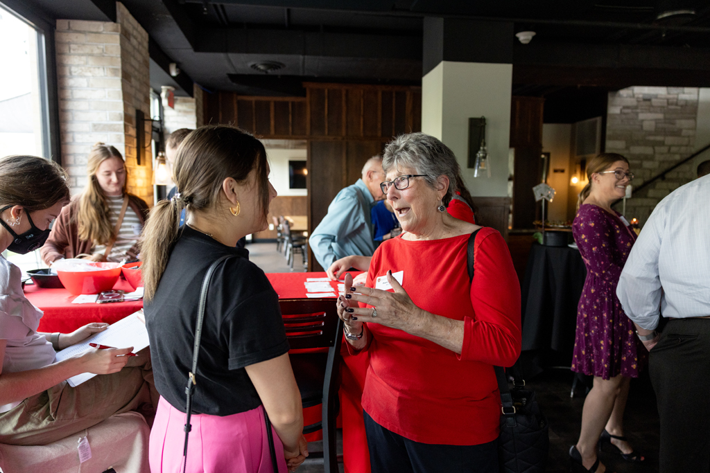Pam Ploetz and another attendee chat