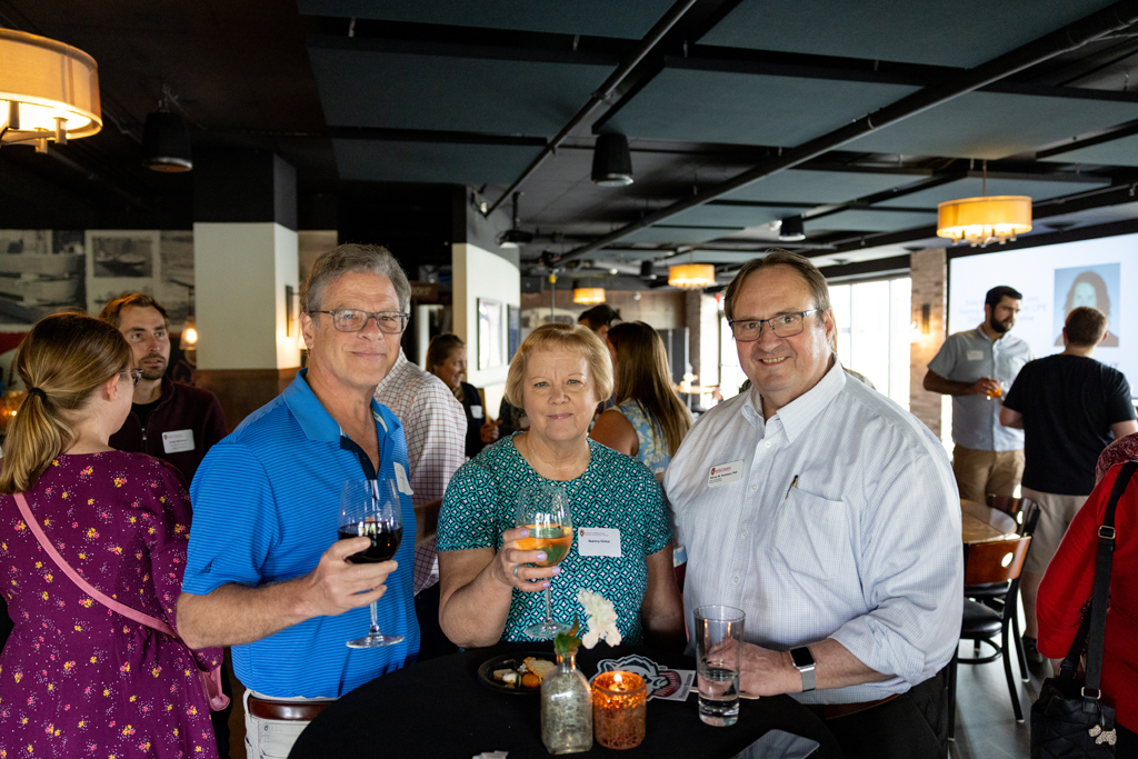 Barry Gidal, Steve Swanson, and another attendee smile for a photo