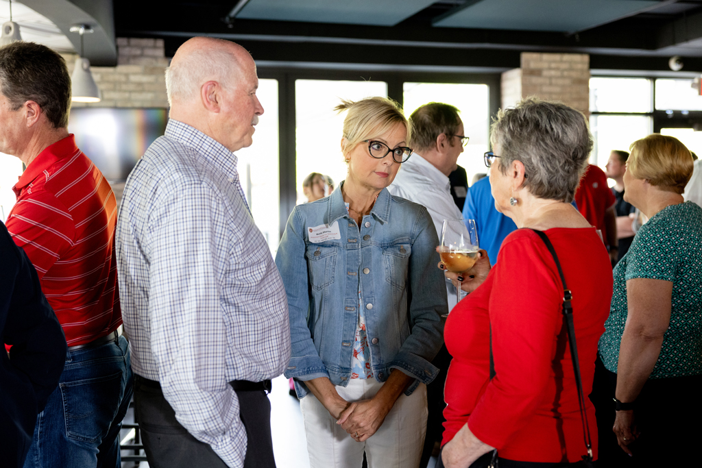 Beth Martin, Pam Ploetz, and Jim Demuth speak in a group