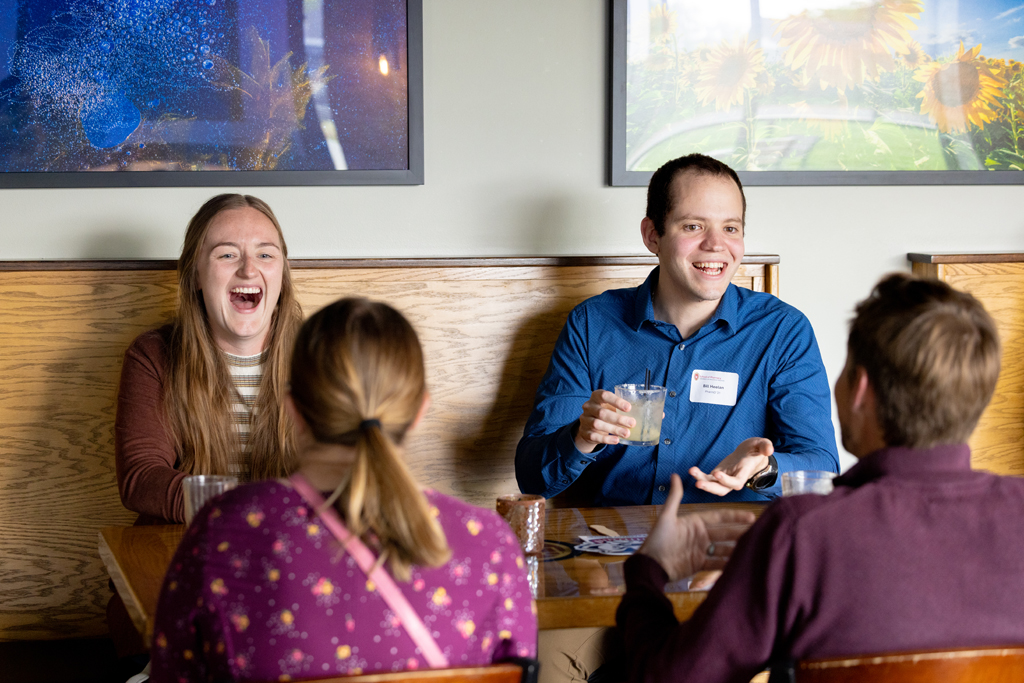 A group of alumni laugh