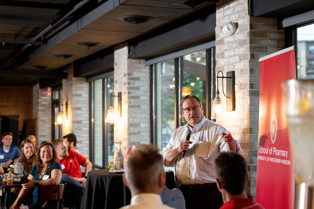 Steve Swanson speaks holding a microphone