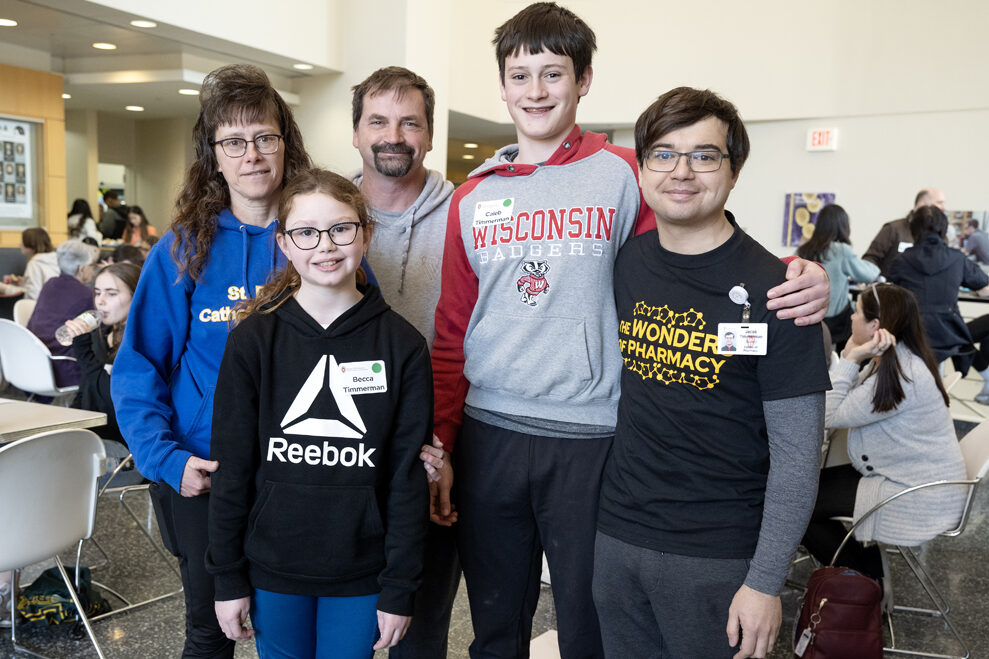 The Wonders of Pharmacy_032024_PLNZ72_6748 PharmD student Jacob Timmerman (far right) grabs a family photo with his family during the Wonders of Pharmacy activities on Saturday, March 2, 2024, at the School of Pharmacy on the campus of UW-Madison. (Photo Paul L. Newby, II) (Ids: Mother Karla, Sister Becca, Dad Todd, and Brother Caleb)