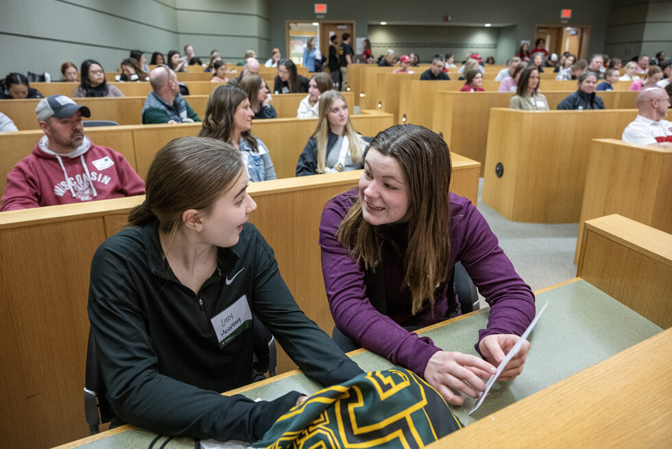 The Wonders of Pharmacy_032024_PLNZ72_6812 High schoolers Lizzy Mesenberg and Alexa Vesely look over the activities during the Wonders of Pharmacy on Saturday, March 2, 2024, at the School of Pharmacy on the campus of UW-Madison. (Photo Paul L. Newby, II)