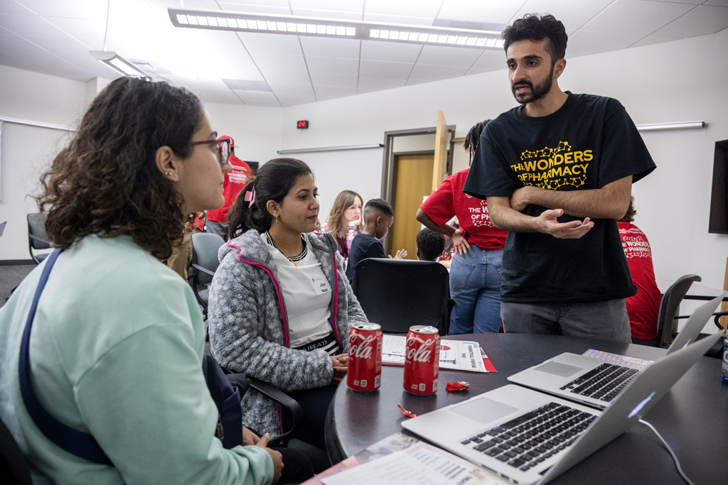 The Wonders of Pharmacy_032024_PLNZ72_7041 Third-year PharmD student Talha Mohammad chats with (l to r) Jana Alhuniti and Jiya Naik about the MEDSMART: Adventures in PharmaCity game during the Wonders of Pharmacy on Saturday, March 2, 2024, at the School of Pharmacy on the campus of UW-Madison. (Photo Paul L. Newby, II)