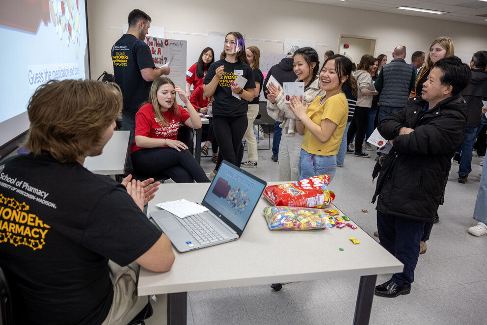 The Wonders of Pharmacy_032024_PLNZ72_7094 Alla Vang and Megan Vang (right) try their luck with the Dose Detectives game during the Wonders of Pharmacy on Saturday, March 2, 2024, at the School of Pharmacy on the campus of UW-Madison. (Photo Paul L. Newby, II)