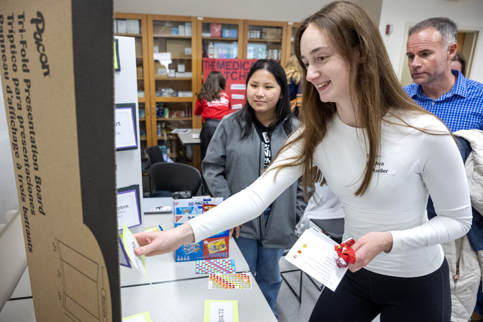 The Wonders of Pharmacy_032024_PLNZ72_7165 As her father, Bill Mueller, looks on, Ava Mueller tries her luck as she plays The Drug Store Cowboys activity during the Wonders of Pharmacy on Saturday, March 2, 2024, at the School of Pharmacy on the campus of UW-Madison. (Photo Paul L. Newby, II)