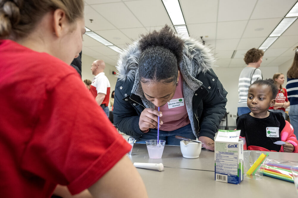The Wonders of Pharmacy_032024_PLNZ72_7506 Baby sister Romi Gomez forms her mouth to blow alongside her older sister Mercy Gomez, who tries to blow bubbles while trying the Gas Busters activity during the Wonders of Pharmacy on Saturday, March 2, 2024, at the School of Pharmacy on the campus of UW-Madison. (Photo Paul L. Newby, II)