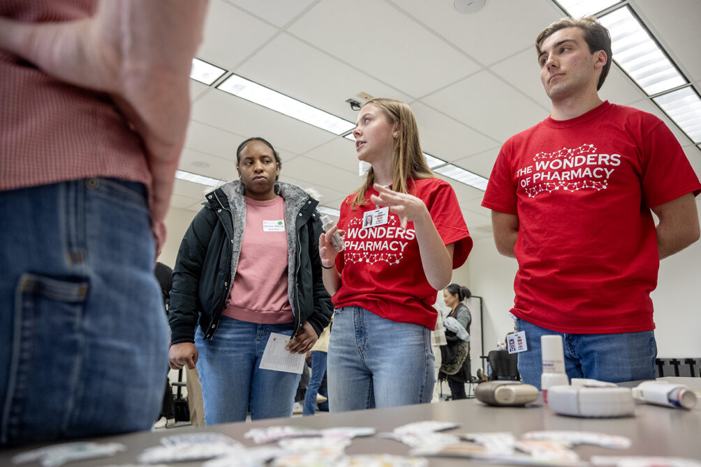 The Wonders of Pharmacy_032024_PLNZ72_7517 Mercy Gomez listens as PharmD student Jasie Goligowski, along with fellow PharmD student Ben Simon, explains the Breath of Fresh Air activity station during the Wonders of Pharmacy on Saturday, March 2, 2024, at the School of Pharmacy on the campus of UW-Madison. (Photo Paul L. Newby, II)