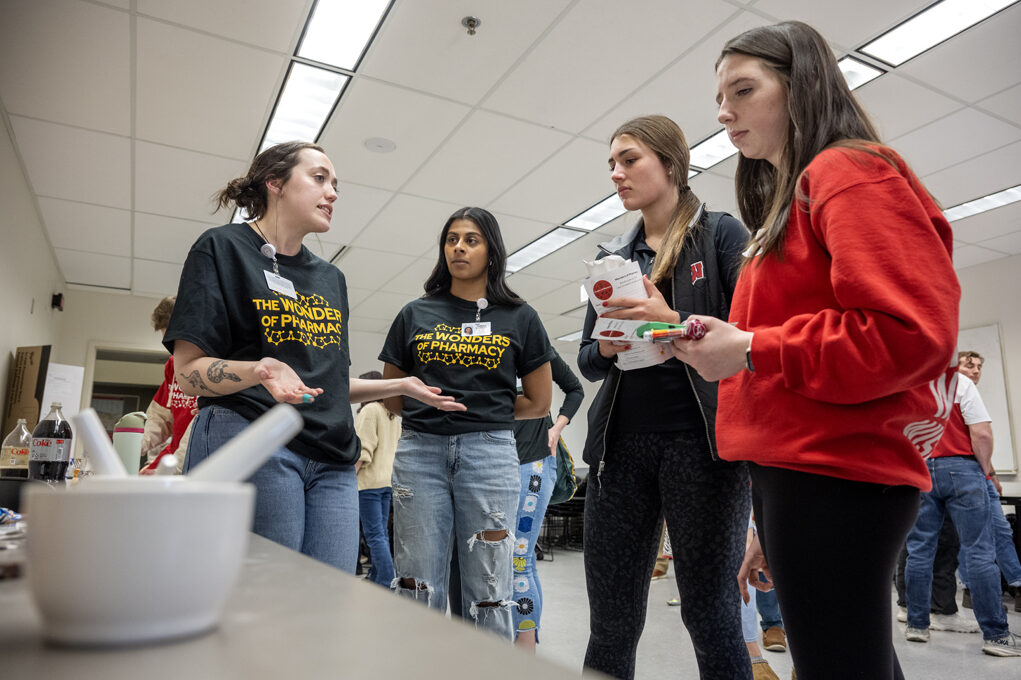The Wonders of Pharmacy_032024_PLNZ72_7550 First-year PharmD student Sydney Van Otterloo explains the object of the Rx-ceptional Compounding activity to Rylee Betthauseer and Lily Dunsirn during the Wonders of Pharmacy on Saturday, March 2, 2024, at the School of Pharmacy on the campus of UW-Madison. (Photo Paul L. Newby, II)