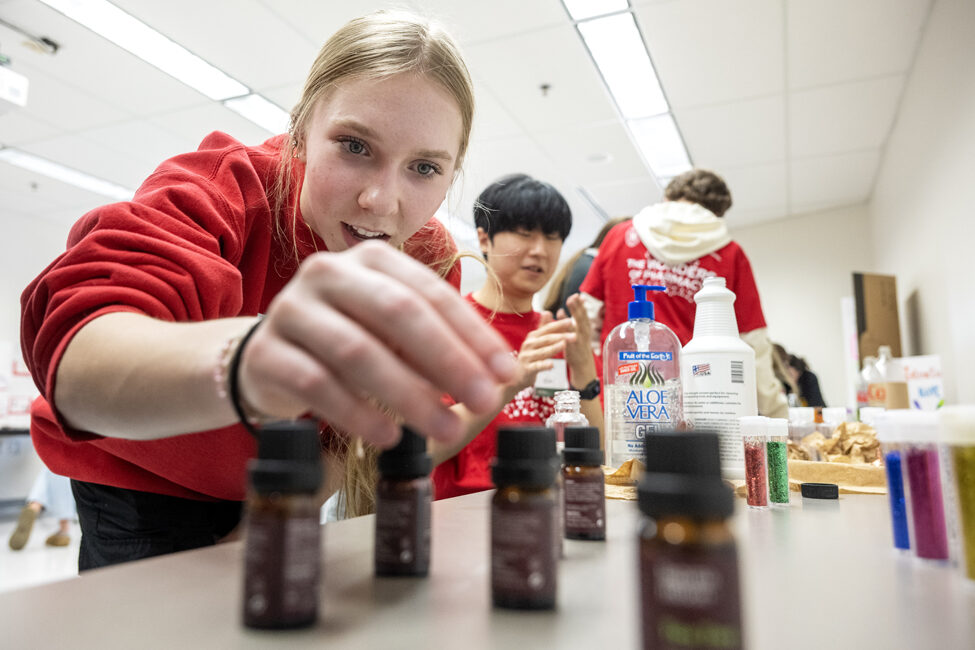 The Wonders of Pharmacy_032024_PLNZ72_7610 Brooke Siebert reads the different types of scents for her hand sanitizer while trying out the Compounding Crazies activity during the Wonders of Pharmacy on Saturday, March 2, 2024, at the School of Pharmacy on the campus of UW-Madison. (Photo Paul L. Newby, II)