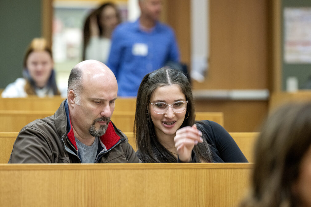 The Wonders of Pharmacy_032024_PLNZ9_5476 Paolo Sali looks over the activity stations with his daughter Rosalia Sali during the start of the Wonders of Pharmacy event on Saturday, March 2, 2024, at the School of Pharmacy on the campus of UW-Madison. (Photo Paul L. Newby, II)