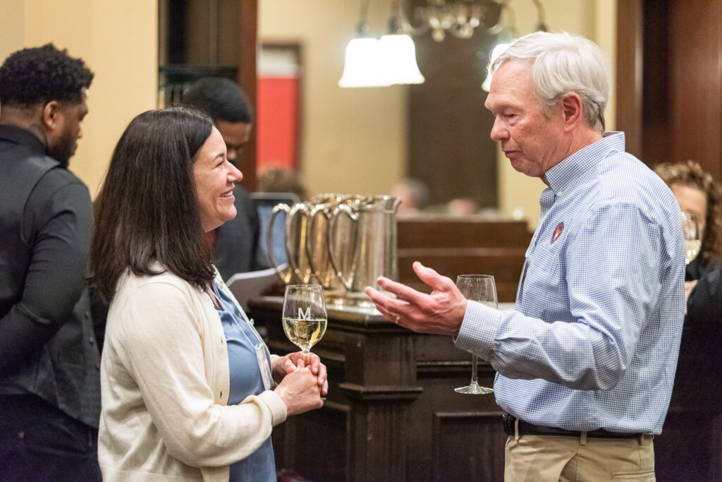 UW-Pharm-Maggianos_20220426_DSC_8450_013 Alumni talking while holding wine glasses