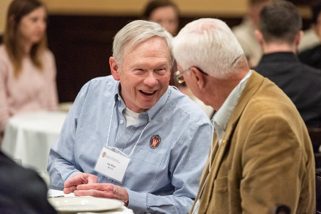UW-Pharm-Maggianos_20220426_DSC_8489_025 Alumni laughing together at a table