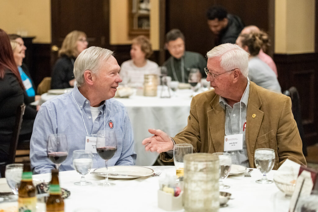 UW-Pharm-Maggianos_20220426_DSC_8526_032 Event attendees speaking together at a table