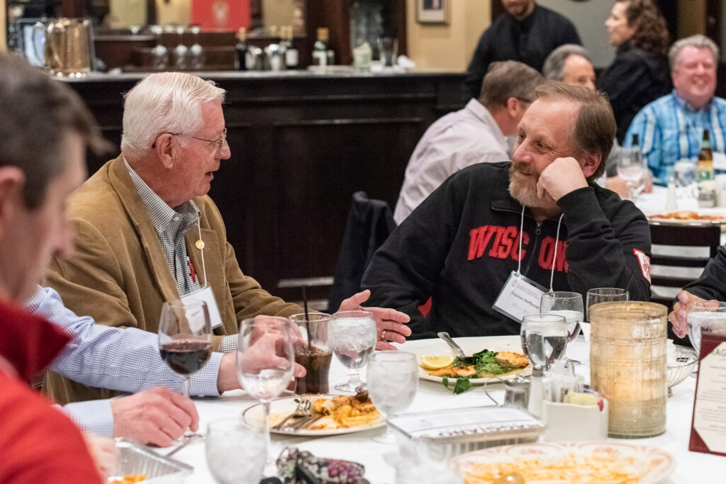 UW-Pharm-Maggianos_20220426_DSC_8580_053 Event attendees speaking together around the table