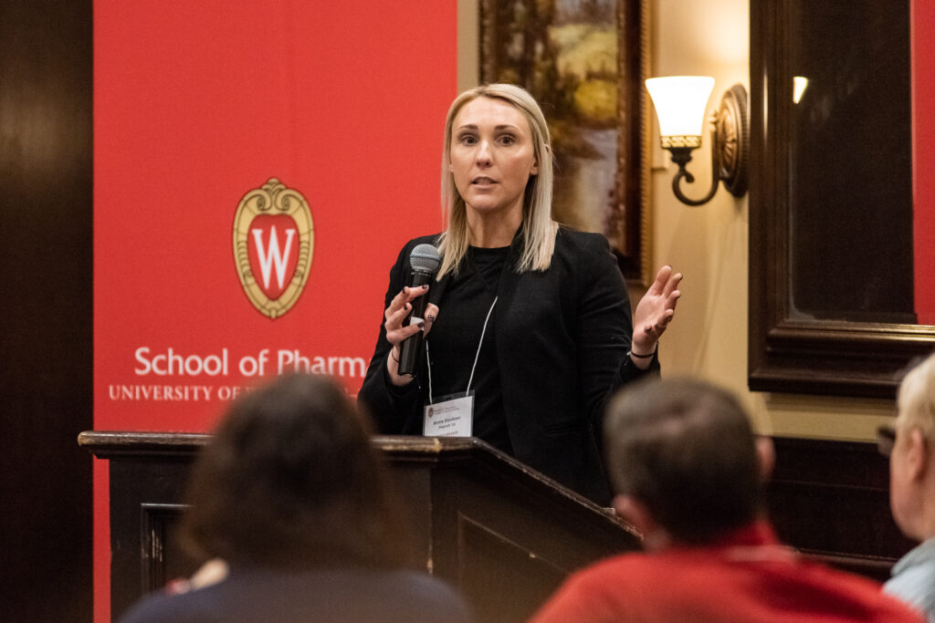 UW-Pharm-Maggianos_20220426_DSC_8839_099 Annie Biesboer (PharmD '10) speaking at the podium