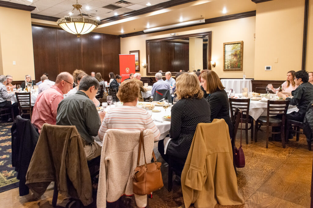 UW-Pharm-Maggianos_20220426__DSC2442_016 Alumni gathered around tables
