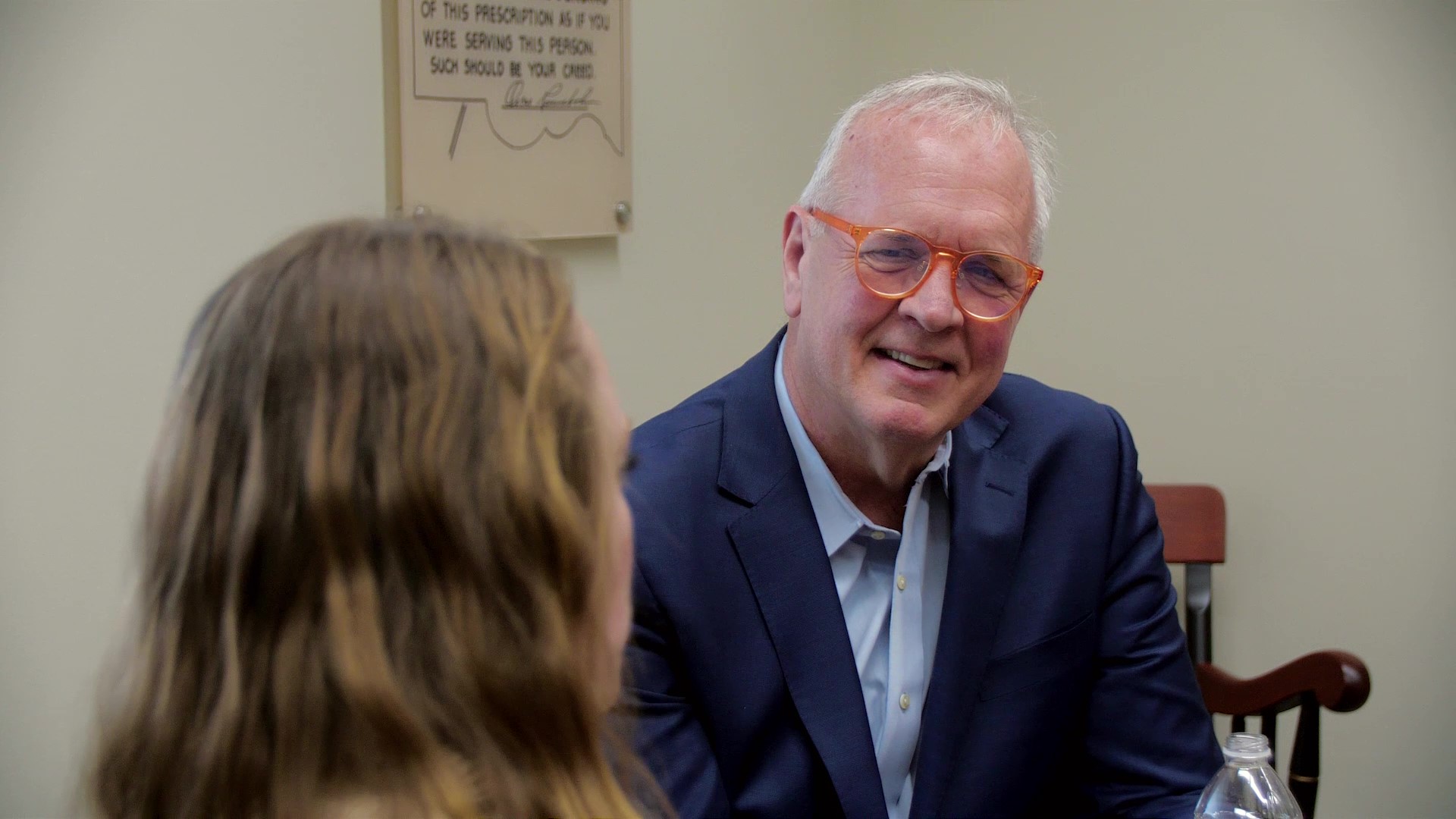 Tom McCourt speaking with a PharmD student who is facing away from the camera