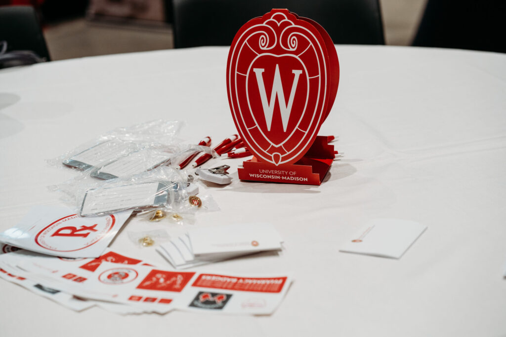 UWL-PAA-18 Items sitting on a table, including pharmacy-branded pens and stickers.