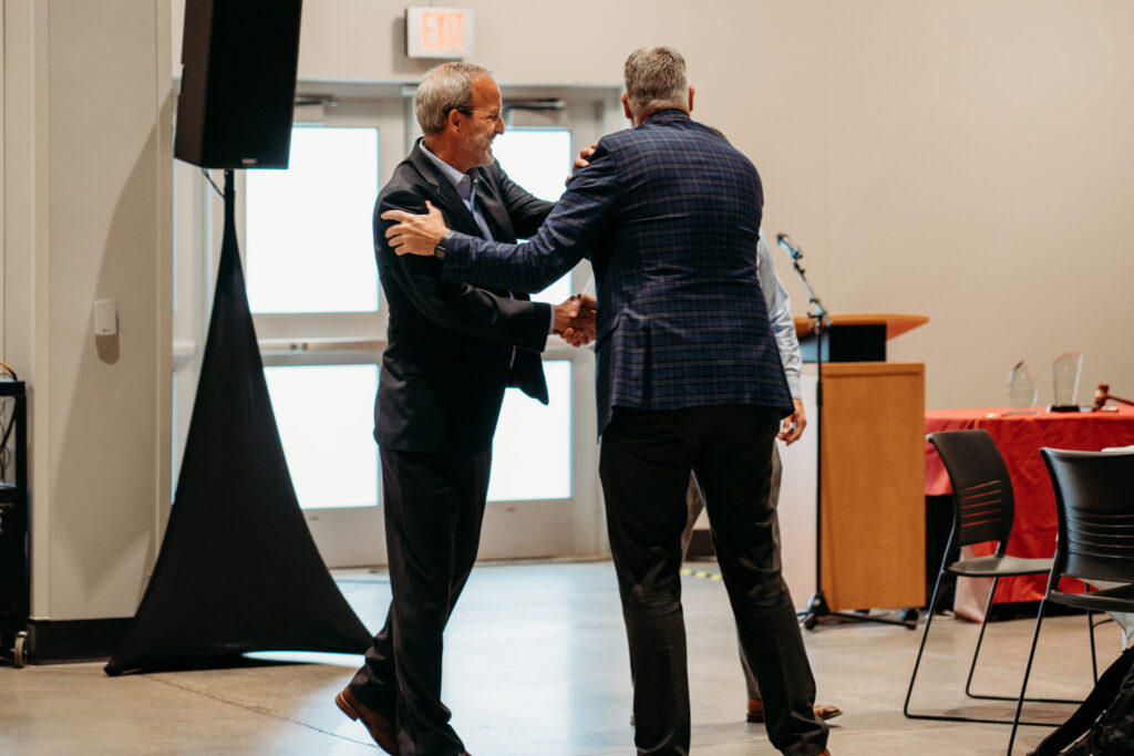 UWL-PAA-25 Dave Mott shakes hands with Andrew Wilcox.