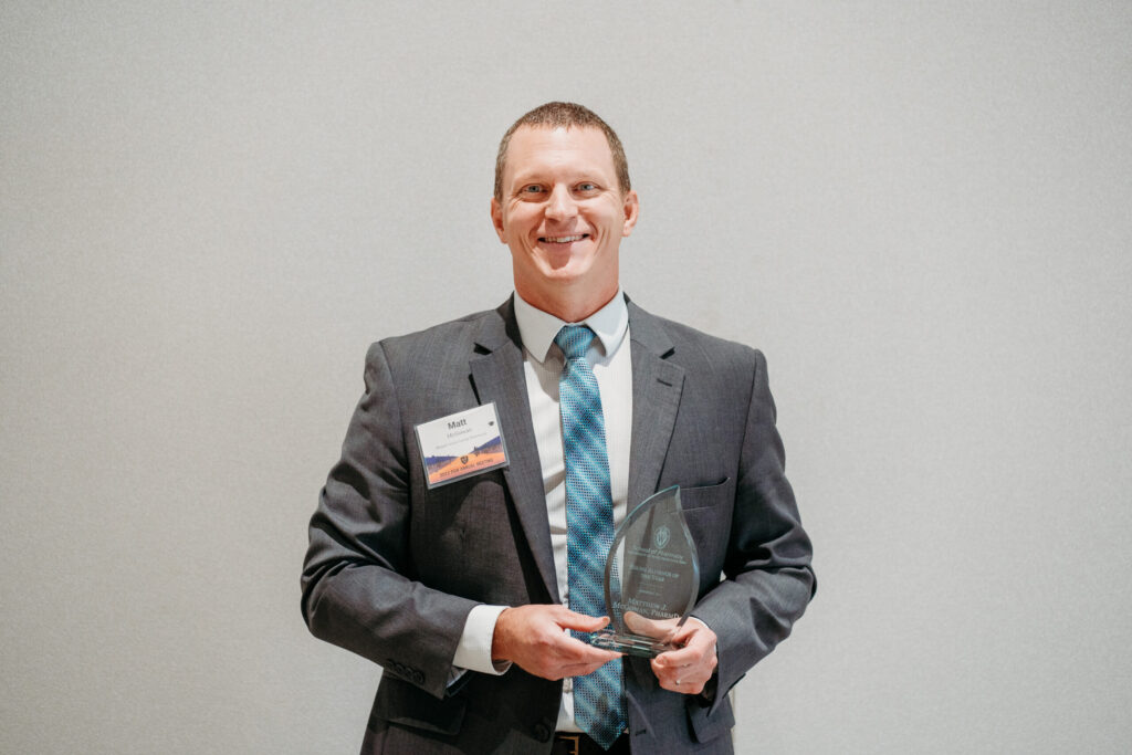 UWL-PAA-52 Matt McGowan smiles with his Young Alum of the Year trophy.