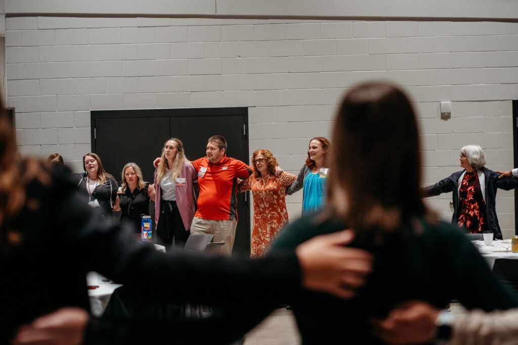 UWL-PAA-74 Alumni arm in arm singing Varsity, at the PAA Luncheon.