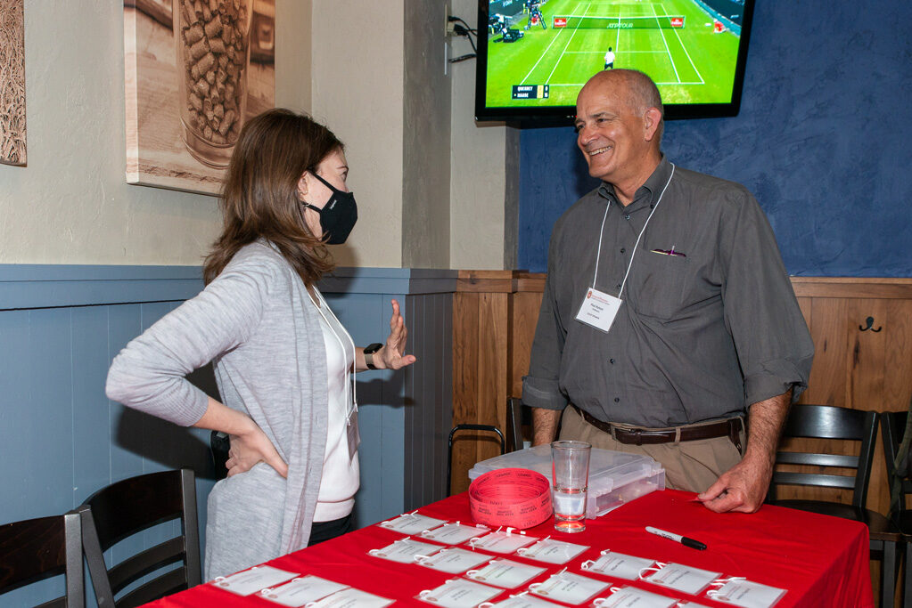 UWPharm-Coopers_2022__DSC4011_001 Alumni and attendees picking up name tags at Cooper's Tavern