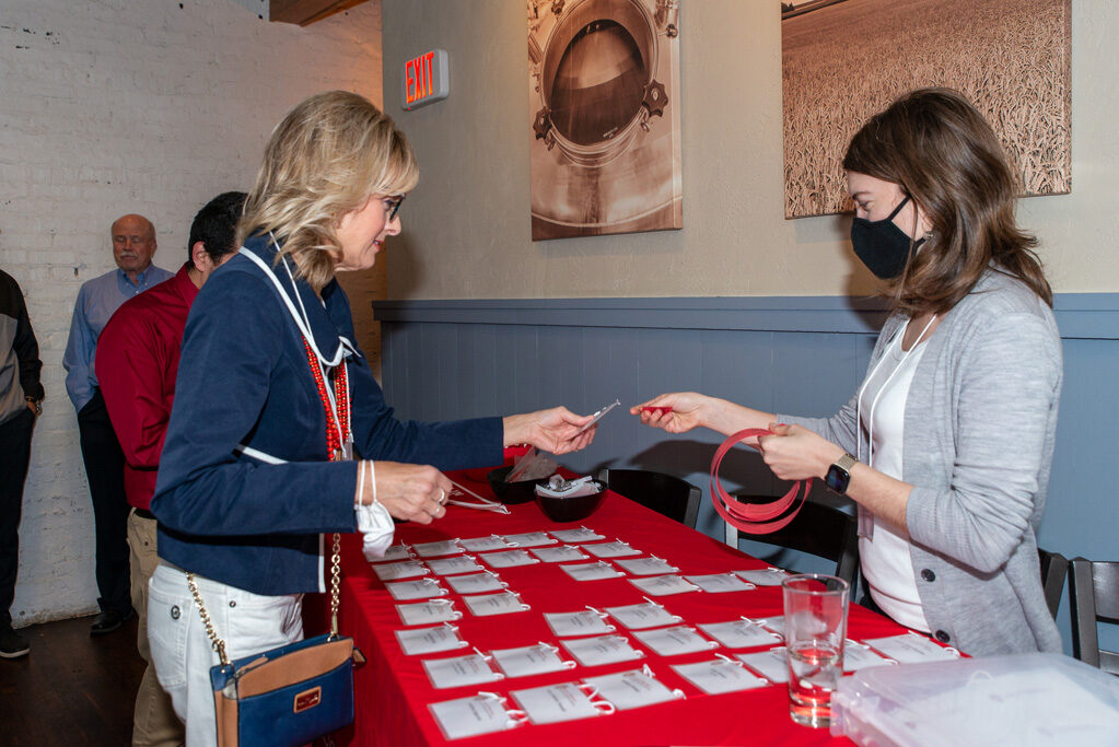 UWPharm-Coopers_2022__DSC4012_002 Alumni and attendees picking up name tags at Cooper's Tavern