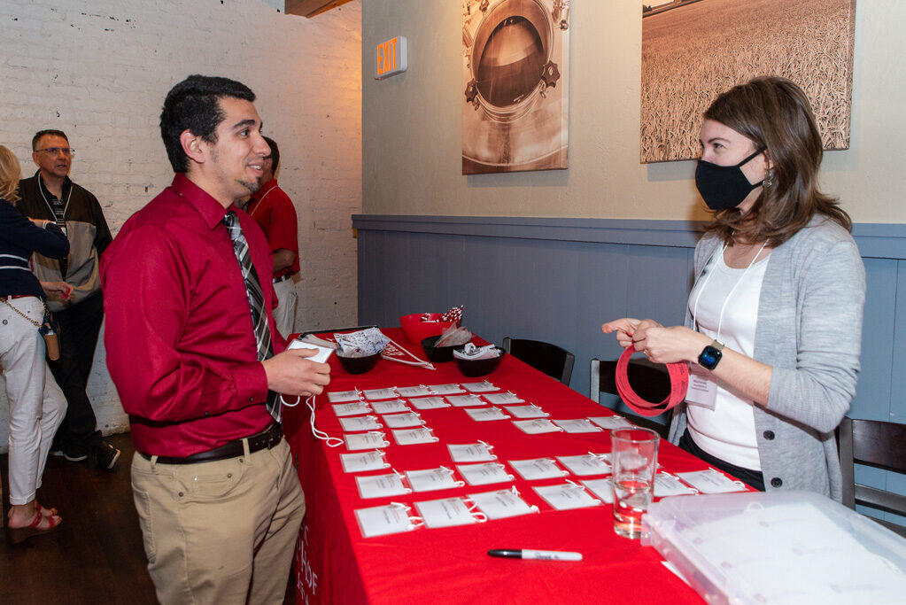 UWPharm-Coopers_2022__DSC4014_003 Alumni and attendees picking up name tags at Cooper's Tavern