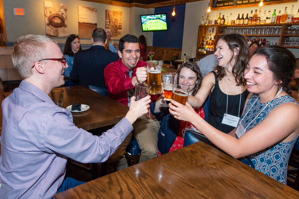 UWPharm-Coopers_2022__DSC4062_021 Alumni and attendees drinking together at Cooper's Tavern